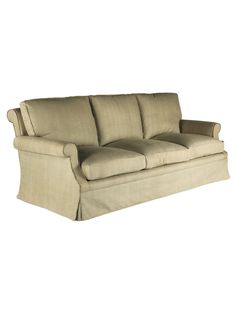 a beige couch sitting on top of a white floor