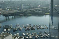 boats are docked in the water next to a bridge