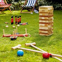 an outdoor game set up in the grass with wooden blocks and croquets