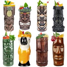 four different tiki style vases with fruit and vegetables in the top one is made out of wood