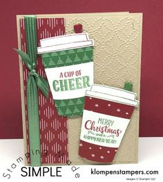 a christmas card with two stockings on the front and green ribbon at the bottom that says, a cup of cheer