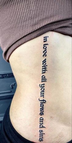 the back of a woman's stomach with words written in cursive writing