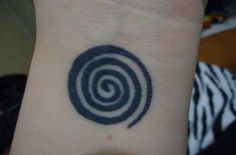 a black and white photo of a wrist with a spiral tattoo on it's arm