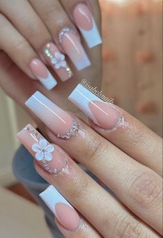 a woman's nails with flowers on them