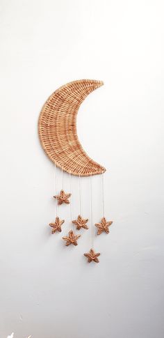 a decorative wall hanging made out of wicker with stars attached to the moon and crescent