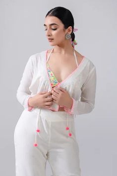 Ivory full sleeve pink thread embroidered short jacket. Comes with multi-colored thread embroidered bralette and sharara pant.
Component: 3
Pattern: Embroidery
Type Of Work: Thread Embroidery
Neckline: V Neck
Sleeve Type: Full Sleeves
Fabric: Cotton Voile
Color: Ivory
Other Details: 
Pink thread embroidered jacket
Pom pom laced tie-up detailing
Pink tassel ornamented sharara pant
Occasion: Resort - Aza Fashions White Chikankari Embroidery Sharara For Spring, White Sharara With Chikankari Embroidery For Spring, Spring White Sharara With Chikankari Embroidery, White Bohemian Sharara For Spring, Sharara Pants, Pink Tassel, Thread Embroidery, Fashion App, Embroidered Shorts