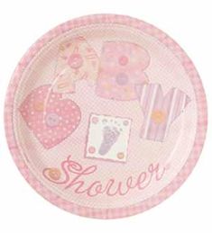 a pink paper plate with hearts and other items on it