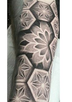 a man's arm with an intricate tattoo design on the left side of his arm