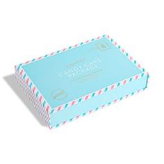 a blue box with pink, white and blue stripes on the lid that says candy cake