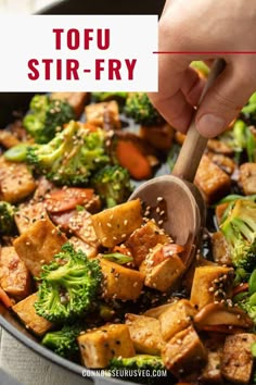 tofu stir fry in a pan with broccoli and carrots