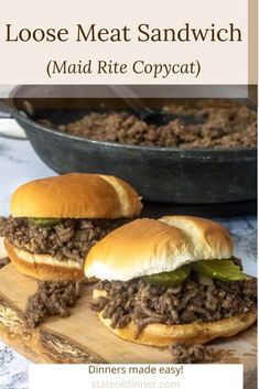 two sloppy joe sandwiches sitting on top of a cutting board next to a skillet