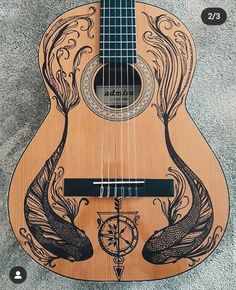 a wooden guitar with an intricate design on it