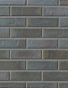 a brick wall that is made out of grey bricks