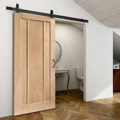 an open wooden door in a white room