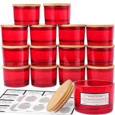 a stack of red glass cups next to a wooden lid