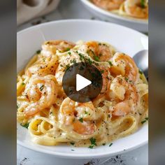 a plate of pasta with shrimp and parsley