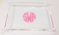 an acrylic monogrammed glass tray with pink letters