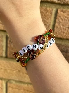 a close up of a person's arm wearing a bracelet with beads and charms