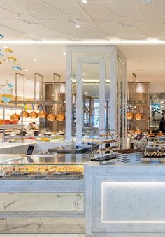 the inside of a restaurant with many items on display in front of glass doors and windows