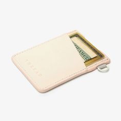 a white wallet with money sticking out of it's front pocket on a white background