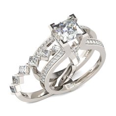 a white gold ring set with princess cut diamonds on the sides and an intricate band