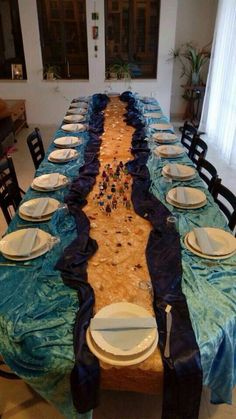 a long table with plates and place settings on it