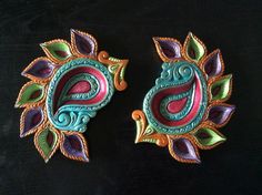 two colorful decorative items on a black surface