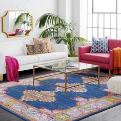 a living room with two couches, a coffee table and a mirror on the wall