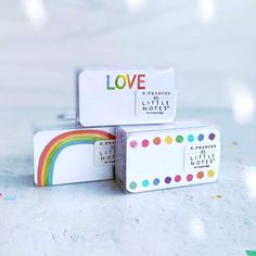 three small boxes are stacked on top of each other with the word love printed on them