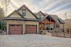 a large house with two garages in the front and one on the other side