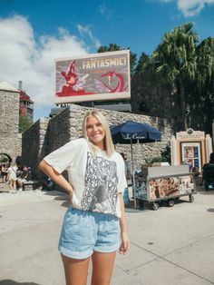 a woman standing in front of a sign for fantassmil with her hands on her hips