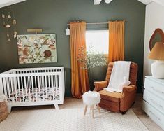 a baby's room with green walls and white furniture