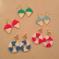 six pairs of earrings made out of perler bead and plastic beads on a table