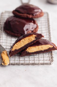 three cookies on a cooling rack with chocolate and peanut butter