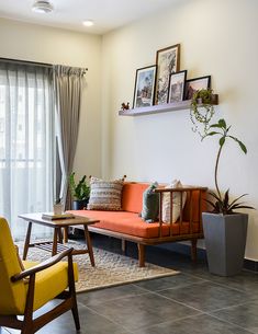 a living room filled with furniture and pictures on the wall