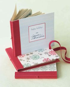 an open book with a red ribbon on the cover and some cards in it that say happy birthday