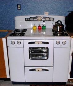 an old fashioned white stove and oven in a kitchen