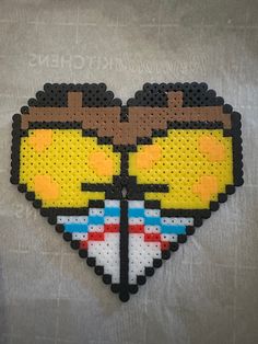 the pixel heart is made out of legos and has two glasses on it's face