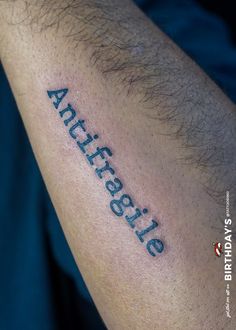 a man's arm with an inscription on it that reads, antiteste