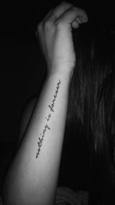 a woman's arm with the words in cursive writing on her left arm