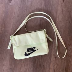 Snap Enclosure, Multiple Compartments, And Nike Details All Over. Dimensions Are Roughly 9” X 6”. Comes With A Zipper Pocket. Unworn But Has Some Dust/Light Staining On The Back (See Last Pic). Could Probably Be Treated To Remove. Good Condition Otherwise! Nike Shoulder Bag With Adjustable Strap, Nike Shoulder Bag With Adjustable Strap For Travel, Nike Shoulder Bag For School, Nike Travel Shoulder Bag With Adjustable Strap, Nike Casual Bag With Adjustable Strap, Functional Nike Bag With Adjustable Strap, Nike Shoulder School Bag, Casual Nike Bag With Adjustable Strap, Nike White Everyday Bags