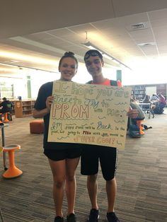 two people holding up a sign that says i hope you are free by the prom