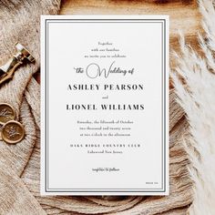 the wedding stationery is laid out on top of a table with some gold scissors