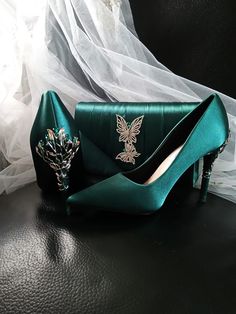 Elevate your evening ensemble with these exquisite Forest Green Satin Evening Shoes. Perfect for a Gothic Wedding, these stunning heels are a must-have for any bride or bridesmaid looking to make a statement. The carved detailing adds a touch of elegance, while the matching clutch bag ensures a coordinated and polished look for any formal event. Step out in style and grace with these luxurious heels and clutch set that are sure to turn heads and make you stand out from the crowd. Specifications: Luxurious Heels, Wedding Heels For Bride, Emerald Green Heels, Heels For Bride, Shoes Board, Stunning Heels, Green Heels, Womens Wedding Shoes, Gothic Wedding