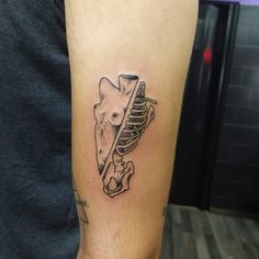 a man's arm with a tattoo of a giraffe holding a bone