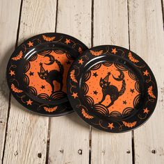 two black and orange plates with cats on them