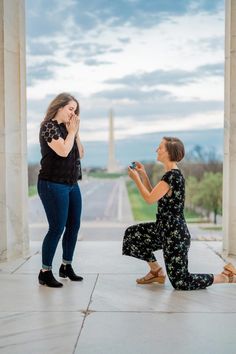 two women kneeling down to take pictures