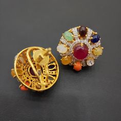 Add a touch of elegance with our Navratan studs, showcasing the nine natural gemstones in a classic design. These studs are crafted to highlight the vibrant colors and spiritual significance of each stone, making them a versatile choice for any occasion. Perfect for adding a pop of color and a hint of tradition to your ensemble, these Navratan studs blend timeless beauty with modern sophistication. Material: 92.5 hallmarked silver Stones: Natural navratan stones, CZ Pin Pendant, Pendant Rings, Natural Beads, Timeless Beauty, Necklaces Bracelets, Classic Design, Natural Gemstones, Gold Earrings, Bangle Bracelets