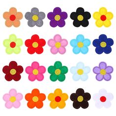 various colors of felt flowers on a white background