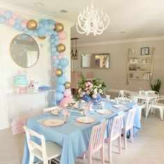 a dining room table with blue and pink decorations